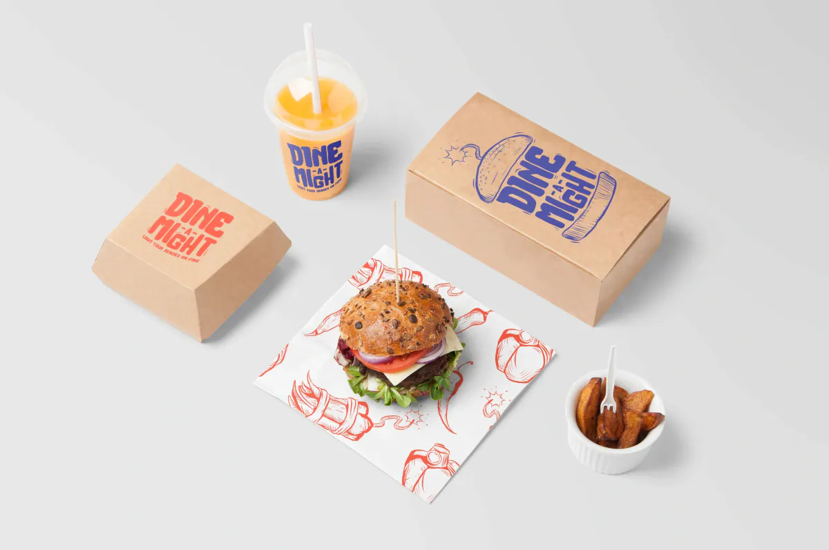 Dine-a-Might packaging with a burger box, drink cup, fries and printed wrapper