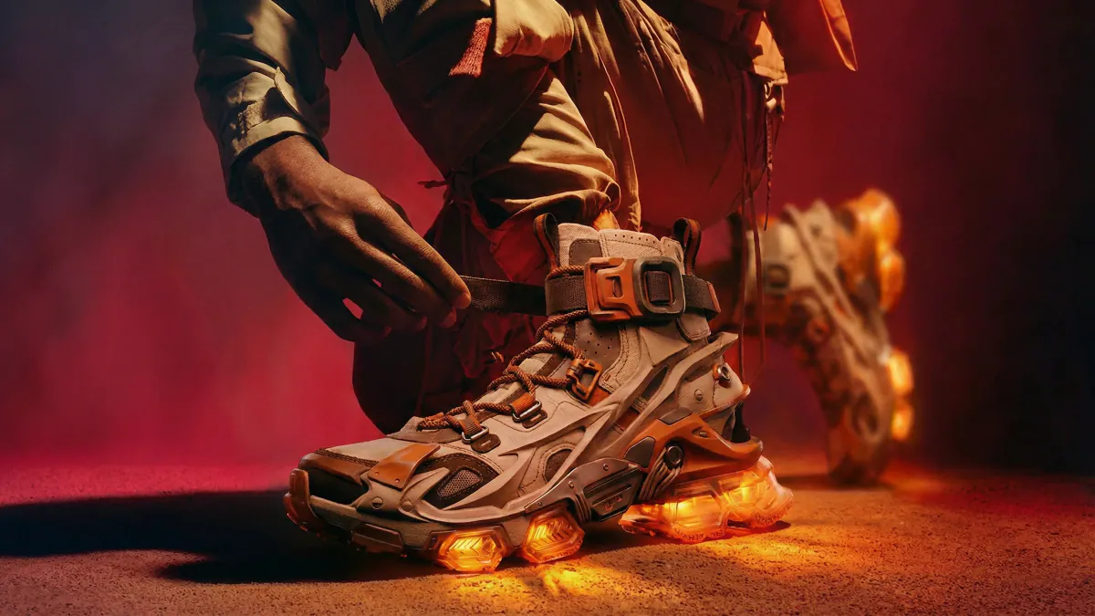 Runner tightening a sneaker strap on red soil