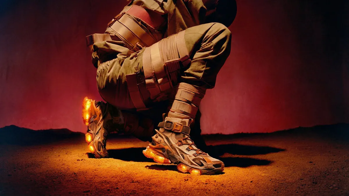 Runner kneeling in red dusk light, sneakers glowing
