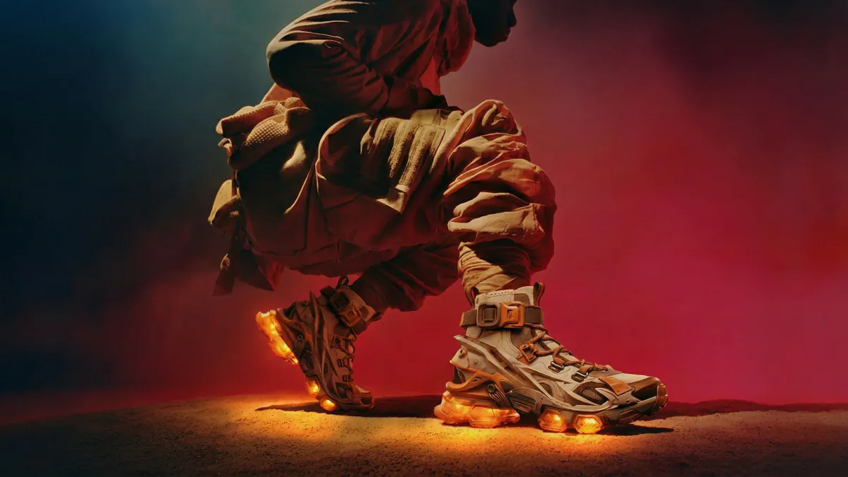 Runner crouched low with glowing sneakers on dark red ground