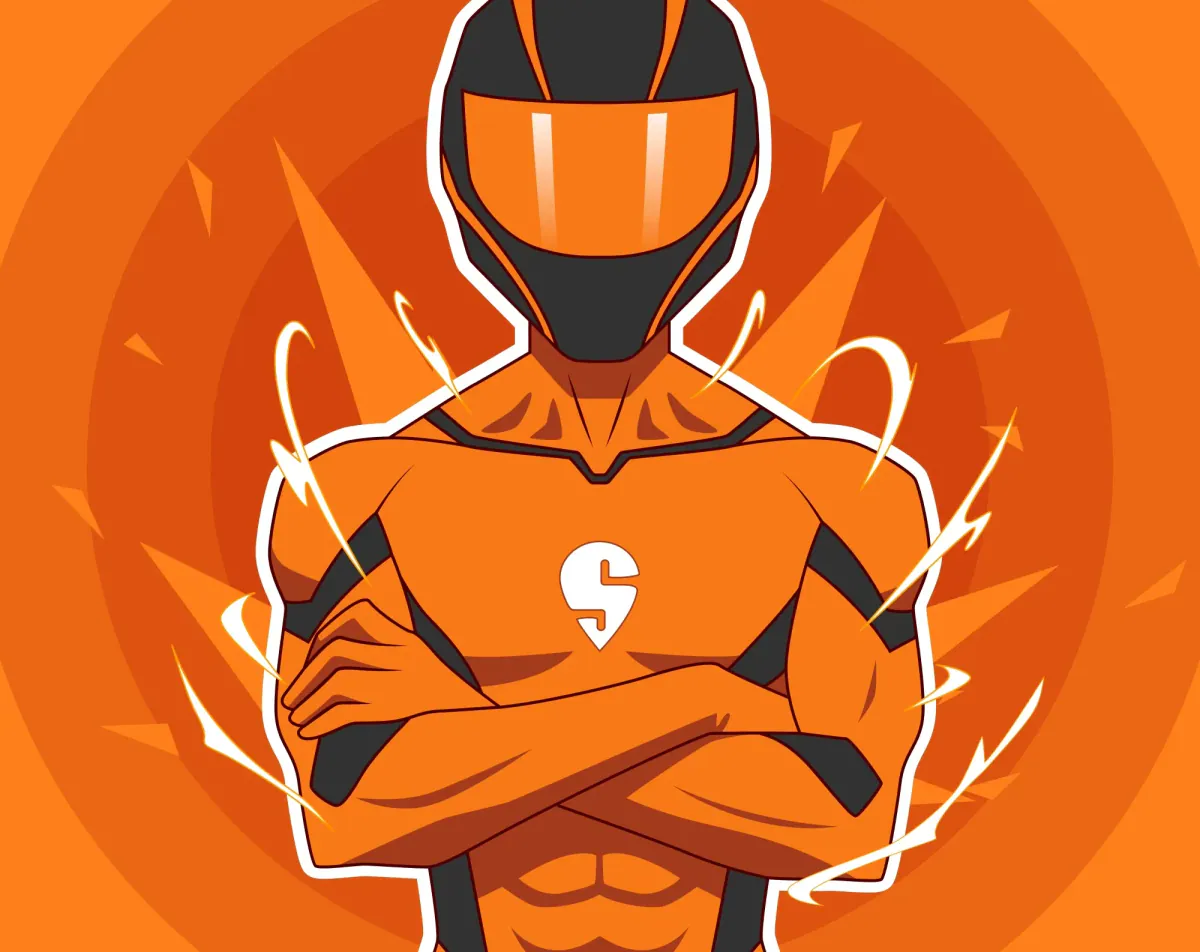 Orange-helmeted rider mascot with arms crossed on an orange burst