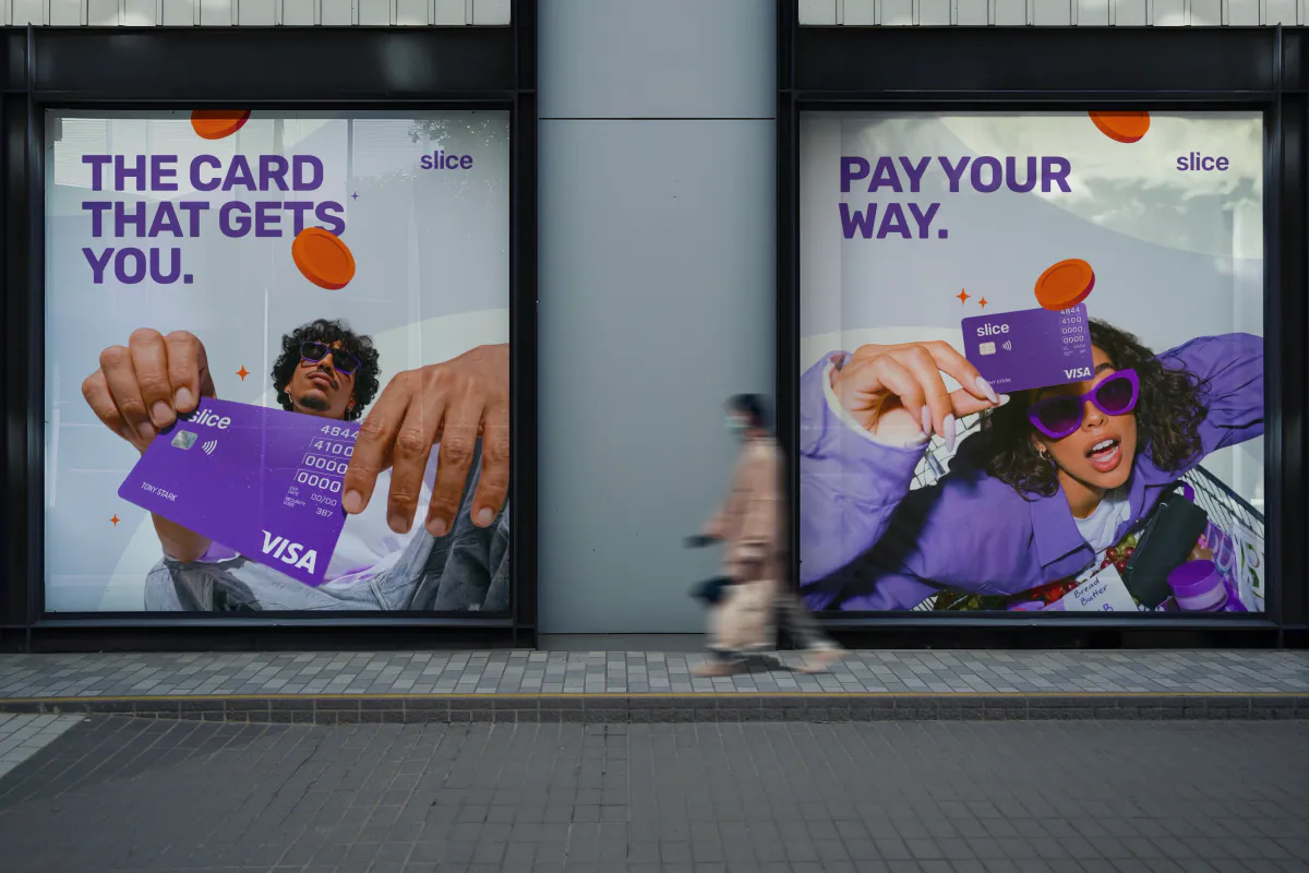 Shop window posters reading The card that gets you and Pay your way