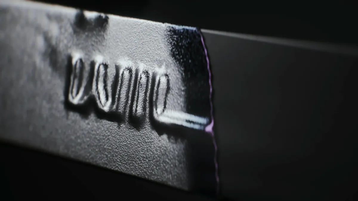 Macro shot of engraved lettering on brushed silver