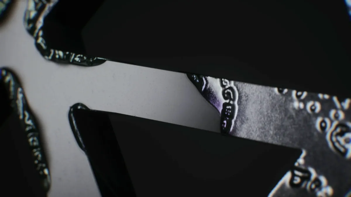 Macro shot of the etched map pattern on the pendant edge