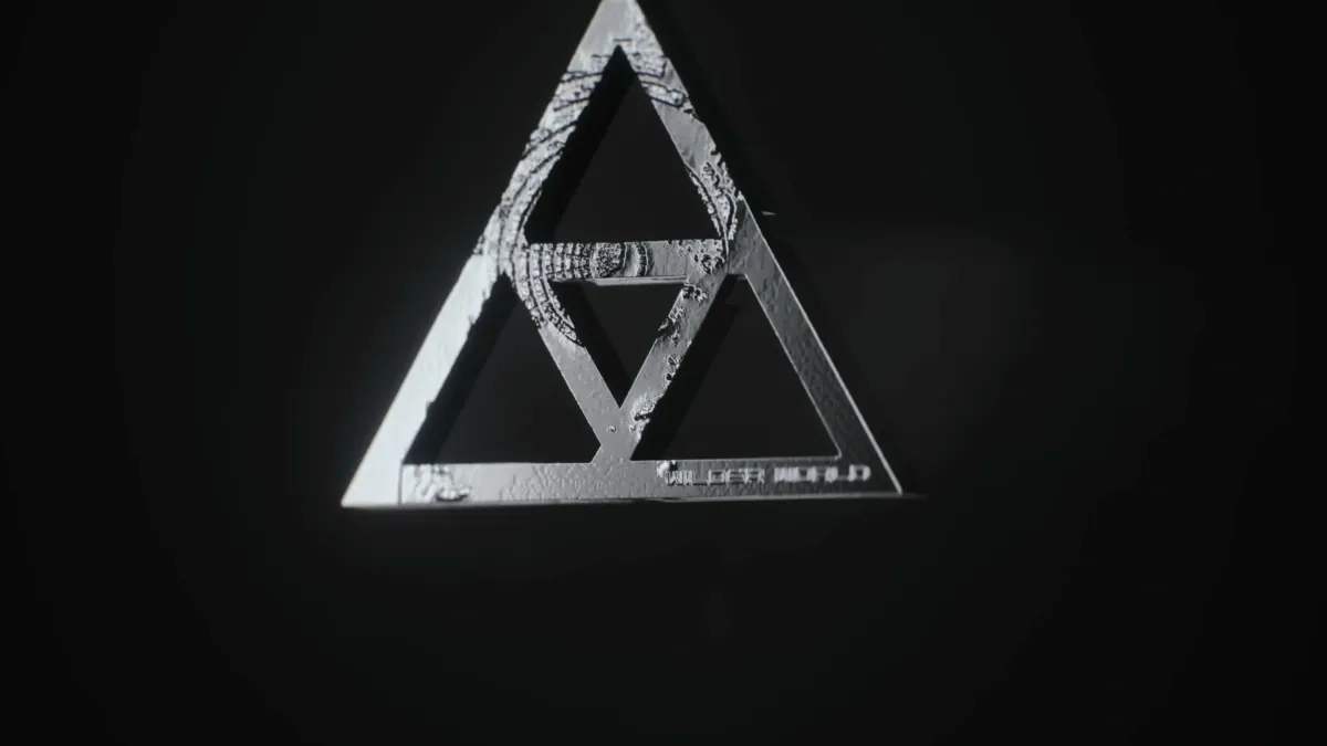 Close-up of the silver triangle pendant with its etched map