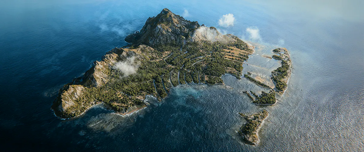 Aerial view of a mountainous island surrounded by sea