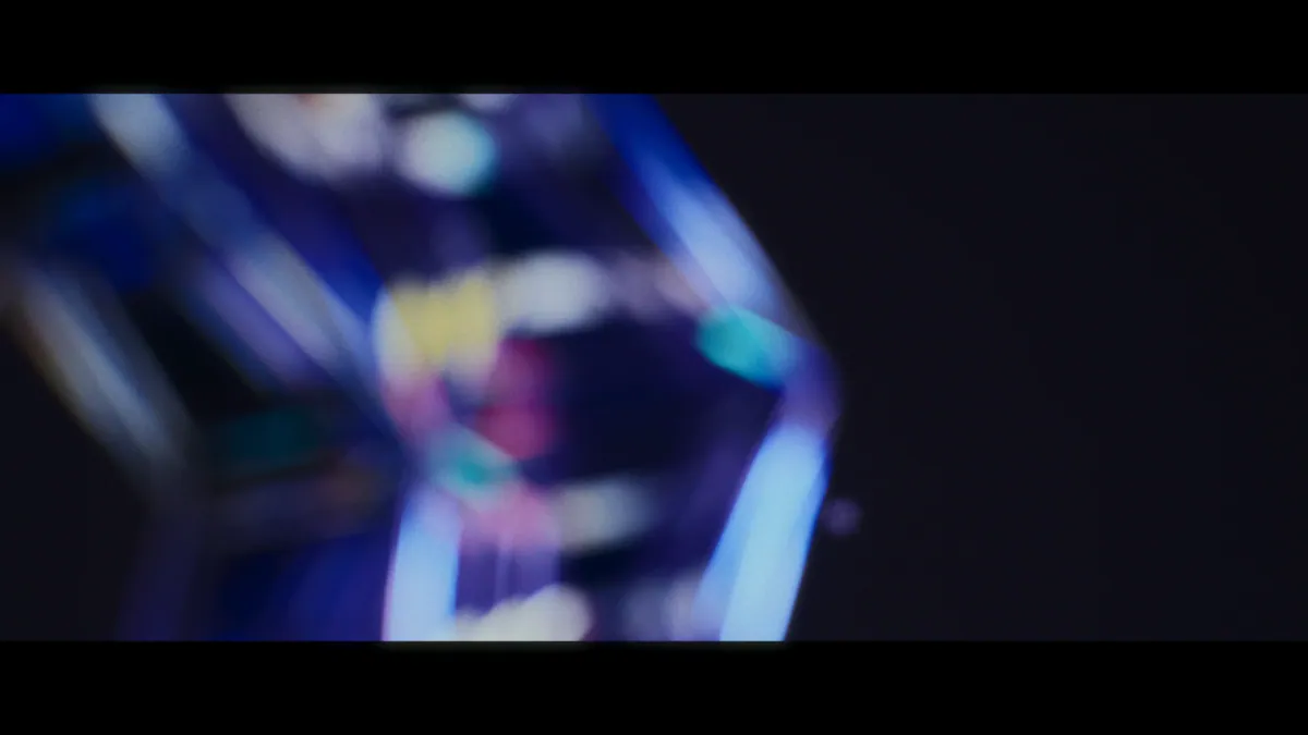 Out-of-focus glass cube glowing blue and pink