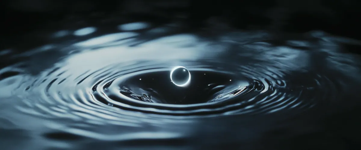 Glowing ring rising from rippling dark water